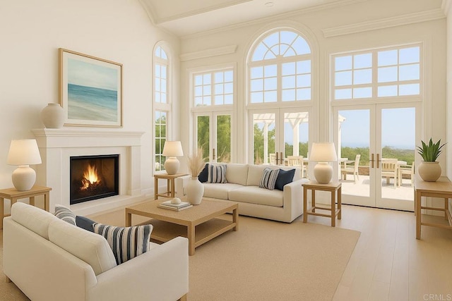 6815 La Jolla Scenic Dr, La Jolla, CA 92037 - living area with a high ceiling, healthy amount of natural light, ornamental molding, wood finished floors, and a warm lit fireplace