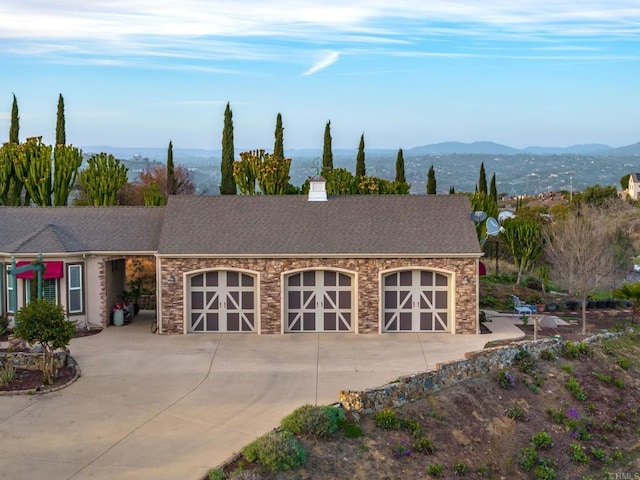 30419 Canyon Estates Rd, Vista, CA 92084 - view of front facade with concrete driveway, a mountain view, an attached garage, and roof with shingles