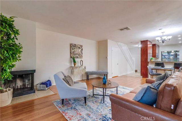 4140 Workman Mill Rd Unit 78, Whittier, CA 90601 - living area featuring a multi sided fireplace, light wood finished floors, and a chandelier