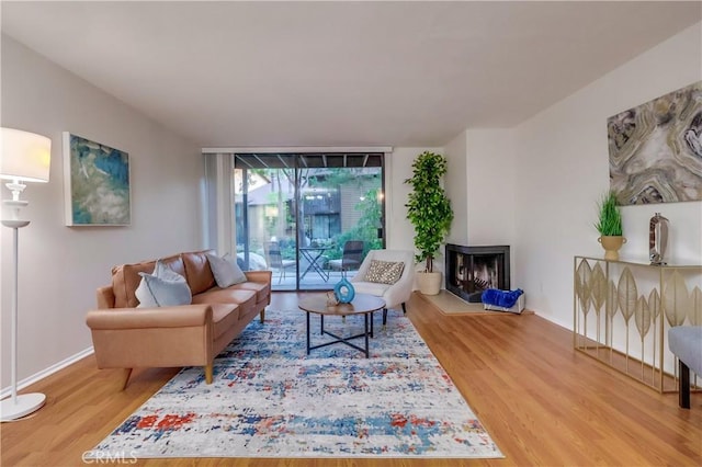 4140 Workman Mill Rd Unit 78, Whittier, CA 90601 - living area featuring wood finished floors and a multi sided fireplace