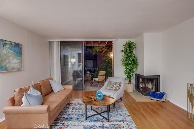 4140 Workman Mill Rd Unit 78, Whittier, CA 90601 - living area featuring a multi sided fireplace and wood finished floors