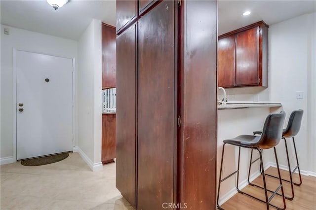 4140 Workman Mill Rd Unit 78, Whittier, CA 90601 - kitchen with a kitchen bar, light countertops, and recessed lighting