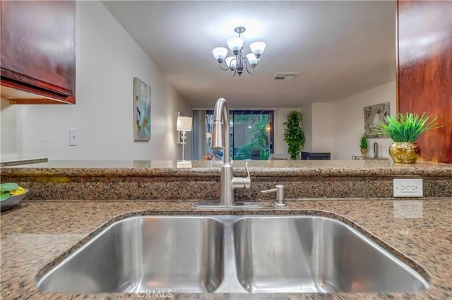 4140 Workman Mill Rd Unit 78, Whittier, CA 90601 - kitchen view of light stone counters and a chandelier