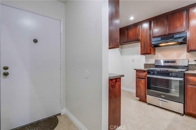 4140 Workman Mill Rd Unit 78, Whittier, CA 90601 - kitchen with gas stove, under cabinet range hood, light tile patterned floors, recessed lighting, and dark stone counters