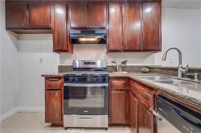 4140 Workman Mill Rd Unit 78, Whittier, CA 90601 - kitchen with stainless steel appliances, exhaust hood, dark stone counters, and light tile patterned floors