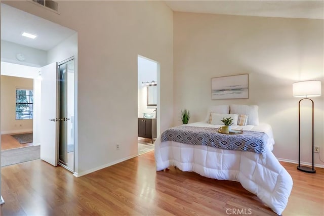 4140 Workman Mill Rd Unit 78, Whittier, CA 90601 - bedroom featuring light wood-type flooring, connected bathroom, and a high ceiling