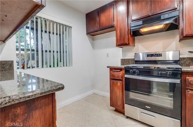 4140 Workman Mill Rd Unit 78, Whittier, CA 90601 - kitchen featuring stainless steel gas range oven, under cabinet range hood, dark stone countertops, and light tile patterned flooring