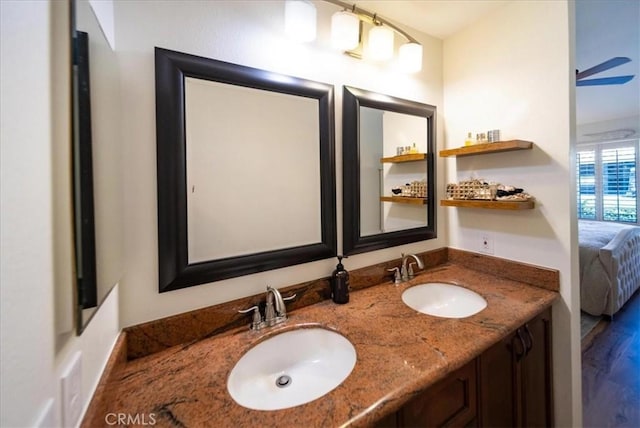 5260 W Palmer Dr, Banning, CA 92220 - bathroom with connected bathroom, double vanity, and wood finished floors