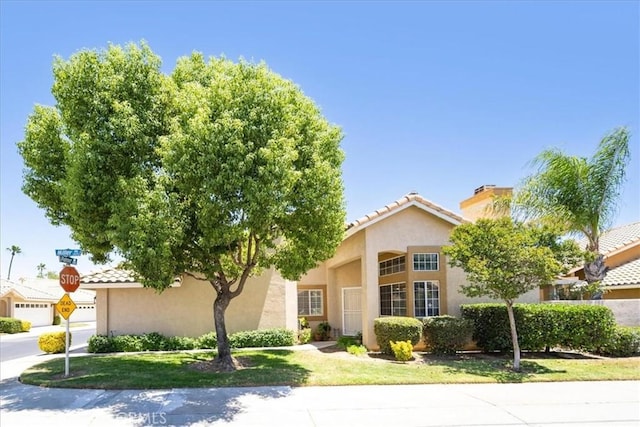5260 W Palmer Dr, Banning, CA 92220 - view of front of home featuring stucco siding, a tile roof, and a chimney