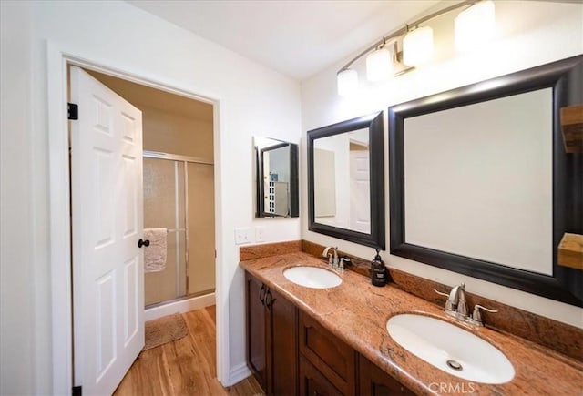 5260 W Palmer Dr, Banning, CA 92220 - full bath featuring wood finished floors, a shower stall, and double vanity
