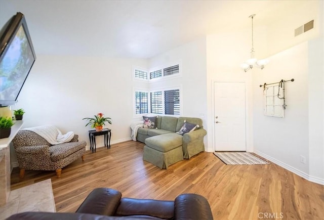 5260 W Palmer Dr, Banning, CA 92220 - living area with light wood-type flooring, a high ceiling, and a chandelier