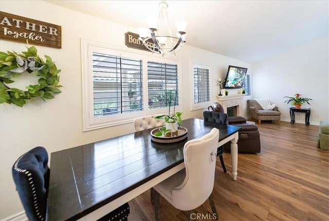 5260 W Palmer Dr, Banning, CA 92220 - dining room with a chandelier, healthy amount of natural light, wood finished floors, and vaulted ceiling