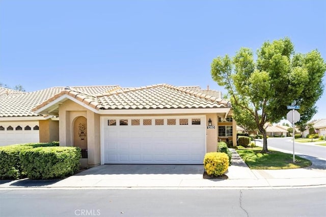 5260 W Palmer Dr, Banning, CA 92220 - view of front of property with stucco siding, an attached garage, concrete driveway, and a tile roof
