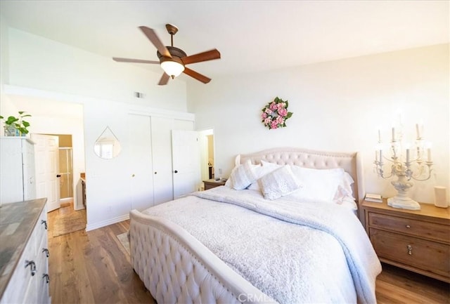 5260 W Palmer Dr, Banning, CA 92220 - bedroom with light wood-style floors, a closet, vaulted ceiling, and a ceiling fan