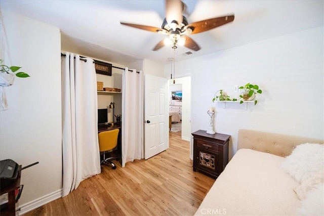 5260 W Palmer Dr, Banning, CA 92220 - bedroom featuring light wood finished floors, a ceiling fan, and a desk