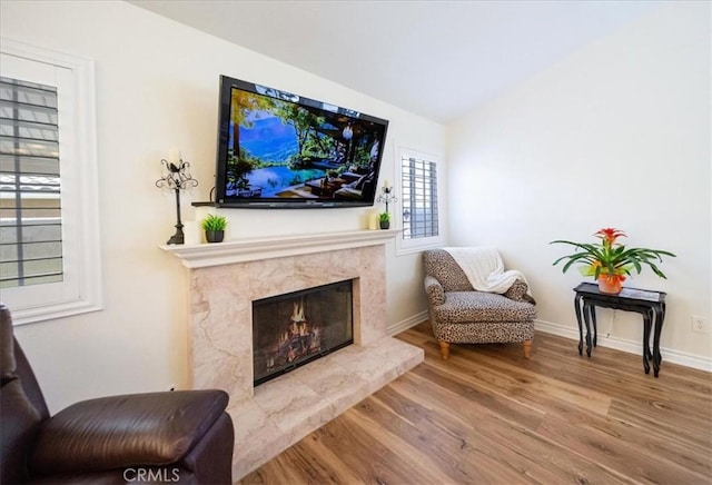 5260 W Palmer Dr, Banning, CA 92220 - living area featuring wood finished floors, vaulted ceiling, and a fireplace