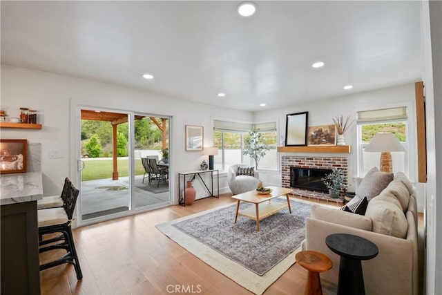 5025 Stonehaven Dr, Yorba Linda, CA 92887 - living room with a brick fireplace, light wood-type flooring, and recessed lighting