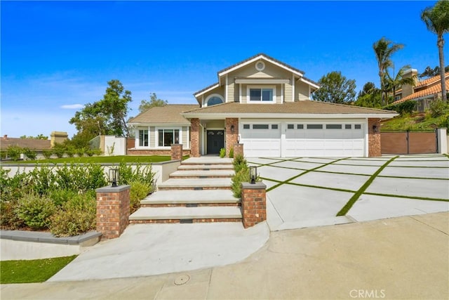 5025 Stonehaven Dr, Yorba Linda, CA 92887 - view of front of property featuring driveway, brick siding, and an attached garage