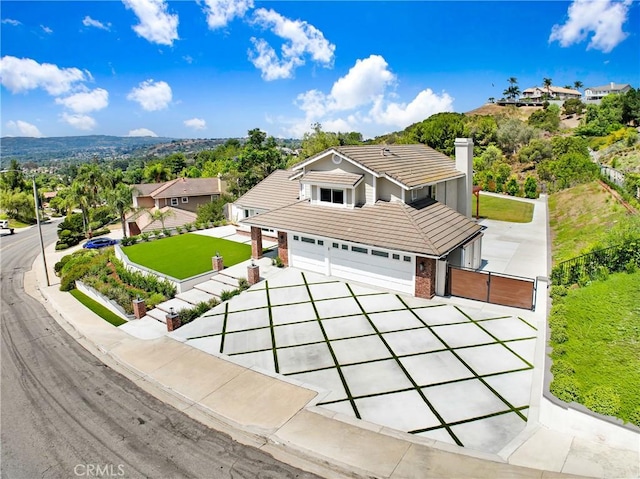 5025 Stonehaven Dr, Yorba Linda, CA 92887 - traditional-style home with a tile roof, a gate, a chimney, driveway, and an attached garage