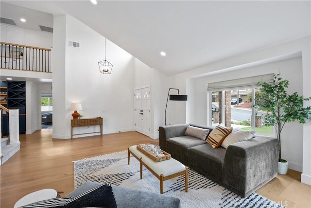 5025 Stonehaven Dr, Yorba Linda, CA 92887 - living area featuring high vaulted ceiling, light wood-style floors, recessed lighting, and stairs