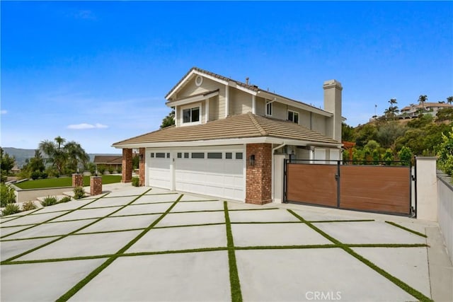 5025 Stonehaven Dr, Yorba Linda, CA 92887 - traditional-style home featuring a tiled roof, a gate, brick siding, and concrete driveway