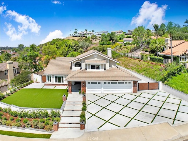 5025 Stonehaven Dr, Yorba Linda, CA 92887 - view of front of house with a chimney, a garage, brick siding, and a tiled roof