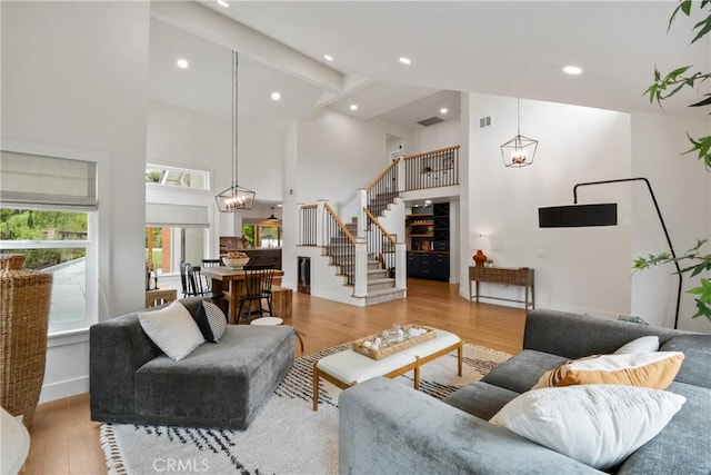 5025 Stonehaven Dr, Yorba Linda, CA 92887 - living room featuring high vaulted ceiling, stairway, wood finished floors, recessed lighting, and a chandelier