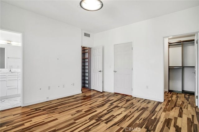 4600 Don Lorenzo Dr Unit 20, Los Angeles, CA 90008 - unfurnished bedroom featuring wood finished floors and connected bathroom