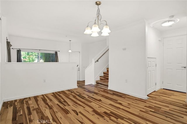 4600 Don Lorenzo Dr Unit 20, Los Angeles, CA 90008 - unfurnished room featuring wood finished floors, stairs, and a chandelier
