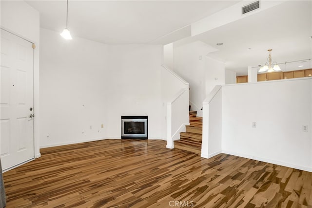 4600 Don Lorenzo Dr Unit 20, Los Angeles, CA 90008 - unfurnished living room featuring wood finished floors, a fireplace, a chandelier, stairs, and a high ceiling