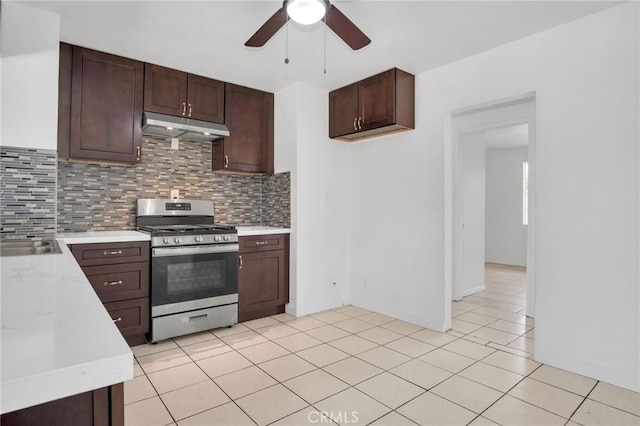 5327 N Rockvale Ave, Azusa, CA 91702 - kitchen featuring stainless steel gas stove, under cabinet range hood, a ceiling fan, light countertops, and backsplash