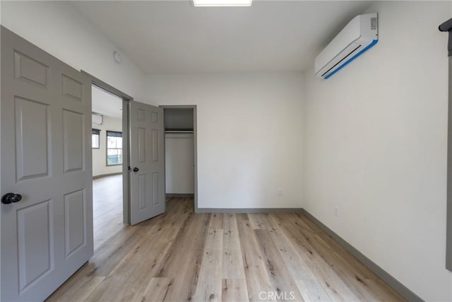 532 W 5th St, Long Beach, CA 90802 - unfurnished bedroom with an AC wall unit, light wood-style flooring, and a closet