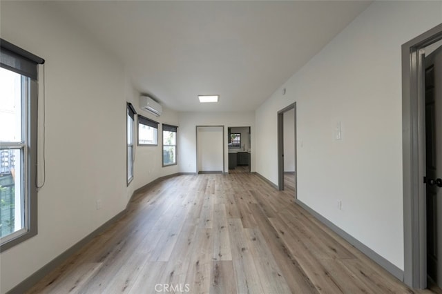 532 W 5th St, Long Beach, CA 90802 - unfurnished living room featuring light wood-style flooring and a wall mounted air conditioner