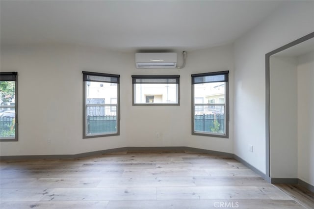 532 W 5th St, Long Beach, CA 90802 - spare room with light wood-style flooring and an AC wall unit