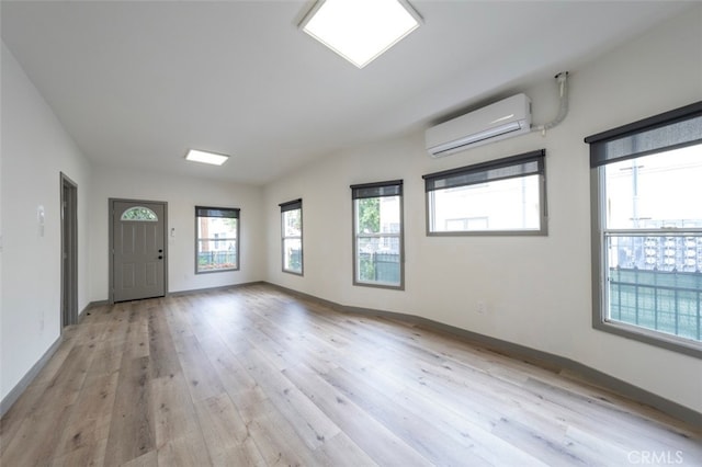 532 W 5th St, Long Beach, CA 90802 - empty room with light wood-type flooring and an AC wall unit