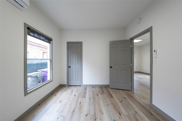 532 W 5th St, Long Beach, CA 90802 - unfurnished bedroom featuring light wood-style flooring and a wall mounted AC