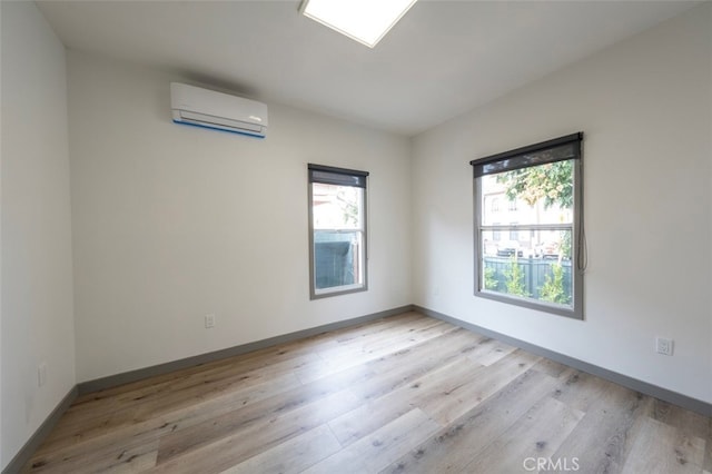 532 W 5th St, Long Beach, CA 90802 - spare room featuring plenty of natural light, light wood-type flooring, and a wall mounted AC