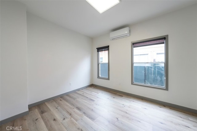 532 W 5th St, Long Beach, CA 90802 - unfurnished room with an AC wall unit and light wood-style floors