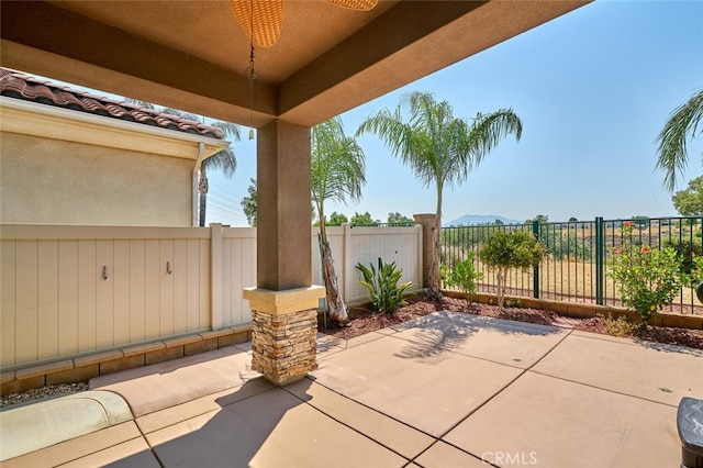 1660 Snowberry Rd, Beaumont, CA 92223 - fenced backyard with a patio, a ceiling fan, and a mountain view