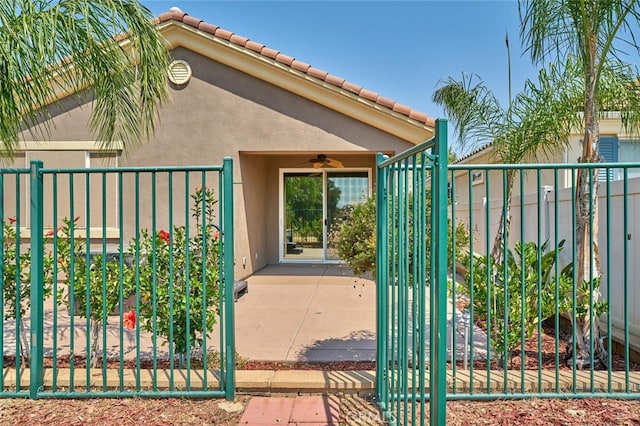 1660 Snowberry Rd, Beaumont, CA 92223 - entrance to property with a ceiling fan, a gate, stucco siding, and a tile roof