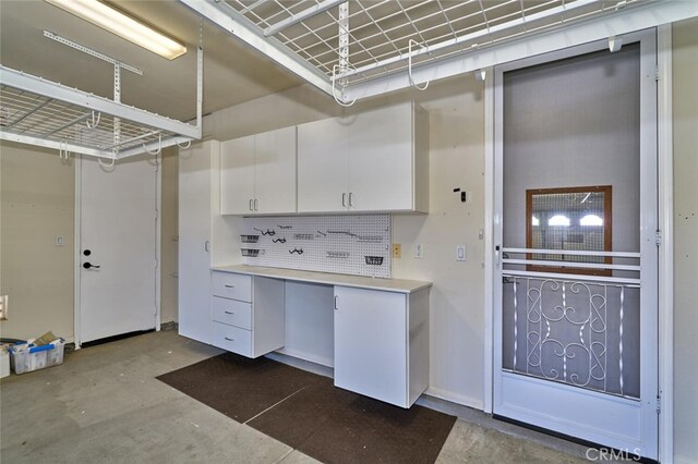 1660 Snowberry Rd, Beaumont, CA 92223 - kitchen with unfinished concrete floors, white cabinetry, light countertops, and decorative backsplash