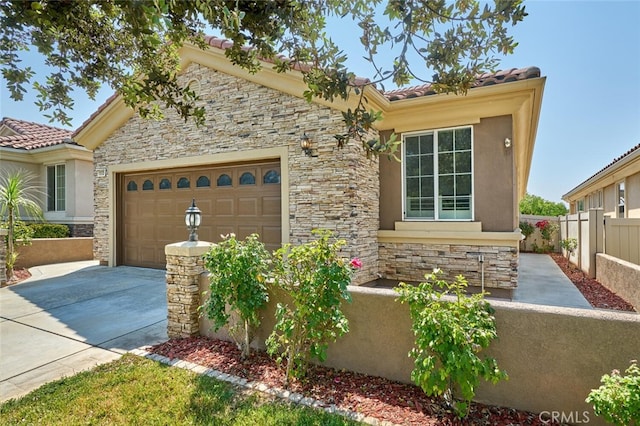 1660 Snowberry Rd, Beaumont, CA 92223 - mediterranean / spanish house with stone siding, a garage, driveway, stucco siding, and a tile roof