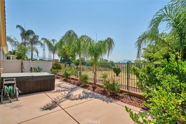1660 Snowberry Rd, Beaumont, CA 92223 - fenced backyard featuring a hot tub, a patio area, and a mountain view