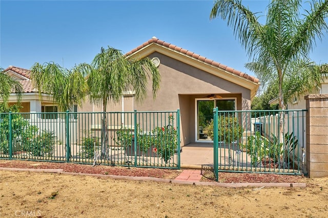 1660 Snowberry Rd, Beaumont, CA 92223 - view of side of property with a tile roof, a ceiling fan, and stucco siding