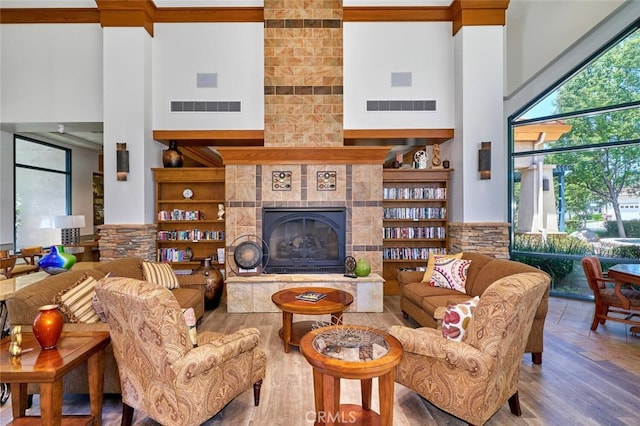 1660 Snowberry Rd, Beaumont, CA 92223 - living room with a towering ceiling, wood finished floors, a tile fireplace, and crown molding