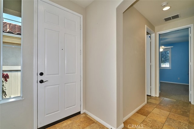 1660 Snowberry Rd, Beaumont, CA 92223 - entryway featuring light stone finish floors and a ceiling fan