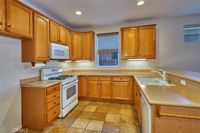 1660 Snowberry Rd, Beaumont, CA 92223 - kitchen with white appliances, recessed lighting, brown cabinetry, a peninsula, and light countertops