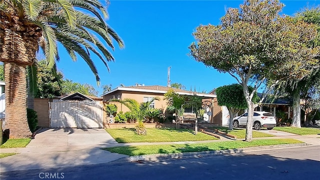 1605 S Birch St, Santa Ana, CA 92707 - view of front of house with driveway, a gate, stucco siding, and a front yard
