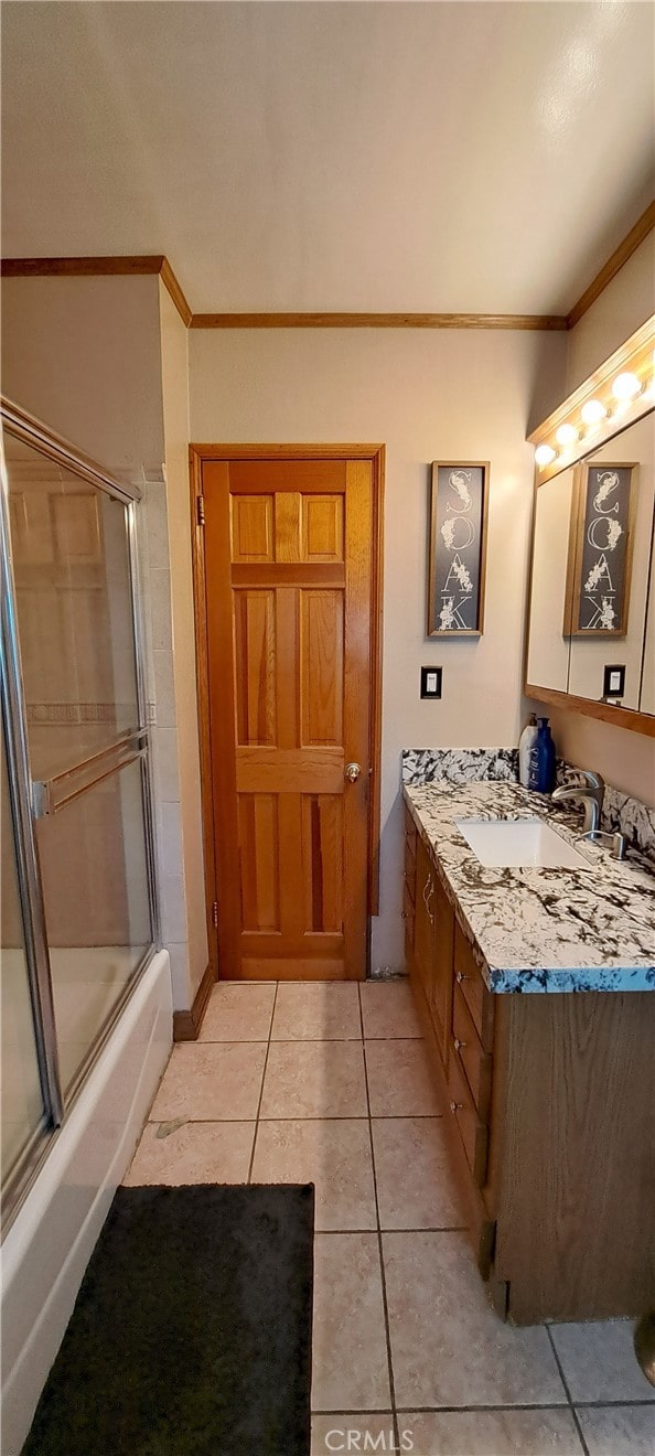 1605 S Birch St, Santa Ana, CA 92707 - bathroom featuring ornamental molding, vanity, tile patterned floors, and shower / bath combination with glass door
