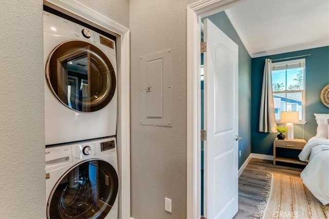 3591 Sacramento Dr Unit 208, San Luis Obispo, CA 93401 - laundry area with stacked washer / drying machine, wood finished floors, and electric panel